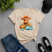 Load image into Gallery viewer, Highland cow pumpkin graphic tee with blue pumpkins and sunflowers